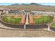 Aerial view of a baseball field with a walking path and community homes in the background at 3369 Ponicelli Ln, Henderson, NV 89044