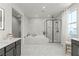 Luxurious bathroom with marble floors, a soaking tub, and a glass-enclosed shower at 3369 Ponicelli Ln, Henderson, NV 89044