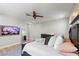 Comfortable bedroom featuring a TV, a large bed, and a mirror at 3369 Ponicelli Ln, Henderson, NV 89044