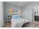 Bright bedroom with modern lighting, comfortable bed, and view of the bathroom at 3369 Ponicelli Ln, Henderson, NV 89044