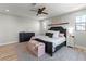 Spacious bedroom with a comfortable bed, hardwood floors, and a modern ceiling fan at 3369 Ponicelli Ln, Henderson, NV 89044