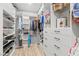 Custom closet featuring open shelving, drawers, and hanging space, designed for efficient organization and storage at 3369 Ponicelli Ln, Henderson, NV 89044