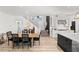Open-concept dining area features a wooden table, seating for six, and hardwood flooring at 3369 Ponicelli Ln, Henderson, NV 89044