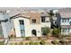 Modern two-story home boasts a charming exterior, complemented by desert landscaping and a secure fence at 3369 Ponicelli Ln, Henderson, NV 89044