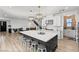Modern kitchen featuring a large island with seating, stainless steel appliances, and elegant pendant lighting at 3369 Ponicelli Ln, Henderson, NV 89044