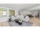 Comfortable living room area with large windows, neutral tones, and adjacent dining area at 3369 Ponicelli Ln, Henderson, NV 89044