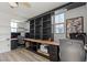 Spacious office with custom built-ins, wood surfaces, a ceiling fan and two windows at 3369 Ponicelli Ln, Henderson, NV 89044