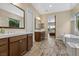 Spacious bathroom featuring double vanities and both a soaking tub and stand-up shower at 34 Costa Tropical Dr, Henderson, NV 89011