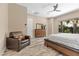 Comfortable bedroom showcases ample natural light, complemented by a cozy chair and decorative flooring at 34 Costa Tropical Dr, Henderson, NV 89011