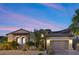 Charming single-story home featuring a well-manicured front yard and a two-car garage, nestled in a desert landscape at 34 Costa Tropical Dr, Henderson, NV 89011