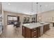 Spacious kitchen featuring an island with seating, stainless steel appliances, and opens to the dining and living areas at 34 Costa Tropical Dr, Henderson, NV 89011