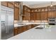 Modern kitchen with stainless steel appliances, ample cabinetry, quartz countertops, and a stylish tile backsplash at 34 Costa Tropical Dr, Henderson, NV 89011