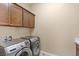 Practical laundry area with modern, front-loading washer and dryer, plus ample cabinet space at 34 Costa Tropical Dr, Henderson, NV 89011