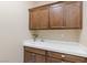 Well-equipped laundry room with bright countertops, a sink, and convenient overhead cabinets at 34 Costa Tropical Dr, Henderson, NV 89011
