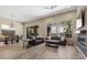 Spacious living room with hardwood floors, comfortable seating, large windows, and seamless transition to the dining area at 34 Costa Tropical Dr, Henderson, NV 89011