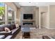 Living room featuring a modern fireplace, decorative tile wall, and large windows with plenty of natural light at 34 Costa Tropical Dr, Henderson, NV 89011