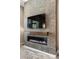 Living room featuring a modern fireplace, decorative tile wall, and hardwood flooring throughout at 34 Costa Tropical Dr, Henderson, NV 89011