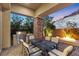 Covered outdoor dining area features a built-in grill, a fire pit, and a stone pillar for entertaining at 34 Costa Tropical Dr, Henderson, NV 89011