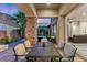 Covered patio features comfortable seating and outdoor dining space with seamless transition to indoor living room at 34 Costa Tropical Dr, Henderson, NV 89011