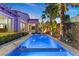 Inviting pool area with modern pool, palm trees, privacy landscaping, and lounge chairs at 34 Costa Tropical Dr, Henderson, NV 89011
