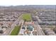 An aerial community view showing swimming pools, a playground, green spaces, and sports courts between homes at 3447 Sw Covilha Ln, Henderson, NV 89044