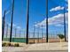 Well-maintained baseball field surrounded by netting, set against a clear blue sky at 3447 Sw Covilha Ln, Henderson, NV 89044