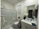 Modern bathroom featuring glass-enclosed shower, vanity with white countertop, and bright natural light at 3447 Sw Covilha Ln, Henderson, NV 89044