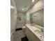 Modern bathroom features double sinks, sleek cabinets, and a glass-enclosed shower at 3447 Sw Covilha Ln, Henderson, NV 89044