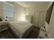 Bright bedroom features a comfortable bed, closet, and ample natural light from a large window at 3447 Sw Covilha Ln, Henderson, NV 89044