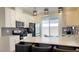 Modern kitchen featuring white cabinets, gray backsplash, and island with seating at 3447 Sw Covilha Ln, Henderson, NV 89044