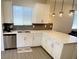 Bright kitchen featuring white cabinets, gray backsplash, quartz countertops, and stylish pendant lighting at 3447 Sw Covilha Ln, Henderson, NV 89044