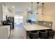 This kitchen features a breakfast bar with sleek white cabinets, and backyard access at 3447 Sw Covilha Ln, Henderson, NV 89044