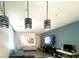 Spacious living room with modern lighting and a sleek entertainment setup at 3447 Sw Covilha Ln, Henderson, NV 89044