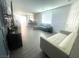 Spacious living room with a comfortable gray sofa and an additional sofa against the wall at 3447 Sw Covilha Ln, Henderson, NV 89044