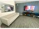 Open-concept living room with stylish gray sofa and TV wall at 3447 Sw Covilha Ln, Henderson, NV 89044