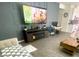 Open-concept living room with stylish gray sofa and TV wall at 3447 Sw Covilha Ln, Henderson, NV 89044