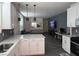 Open concept living space featuring a modern kitchen island and comfortable living room seating at 3447 Sw Covilha Ln, Henderson, NV 89044