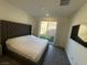 Spacious main bedroom featuring a plush bed, a modern TV, and sliding door access to the backyard at 3447 Sw Covilha Ln, Henderson, NV 89044