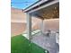 Backyard patio with artificial grass, string lights and brick pavers offers a great outdoor space at 3447 Sw Covilha Ln, Henderson, NV 89044