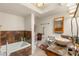 Well-lit bathroom featuring a tub, tiled walls, and a ceramic vessel sink at 3471 One Nation Ave, Las Vegas, NV 89121