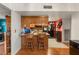 Compact kitchen with eat-in counter, wooden cabinets, and tile flooring at 3471 One Nation Ave, Las Vegas, NV 89121