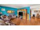 Spacious living room with hardwood floors, entertainment center and comfortable leather seating at 3471 One Nation Ave, Las Vegas, NV 89121