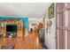 Open concept living area with hardwood floors, entertainment center and dining area at 3471 One Nation Ave, Las Vegas, NV 89121