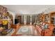 Spacious living room features a stone fireplace, wood floors, large windows, and built-in bookshelves at 3471 One Nation Ave, Las Vegas, NV 89121