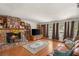 Spacious living room featuring stone fireplace, custom shelving, and large windows at 3471 One Nation Ave, Las Vegas, NV 89121
