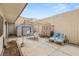 Enclosed backyard patio with lounge chairs, dining table, and shade canopy for outdoor living at 3471 One Nation Ave, Las Vegas, NV 89121