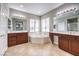 Bathroom with a soaking tub, vanity and large mirrors at 3725 Moonshine Falls Ave, North Las Vegas, NV 89085