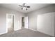 Bedroom featuring a large closet, ceiling fan and doors to ensuite bathroom at 3725 Moonshine Falls Ave, North Las Vegas, NV 89085