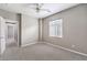 A well-lit bedroom with a neutral color scheme, carpet, and a window for natural light at 3725 Moonshine Falls Ave, North Las Vegas, NV 89085