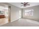 Bedroom with large window, door to a balcony and open to ensuite bathroom at 3725 Moonshine Falls Ave, North Las Vegas, NV 89085